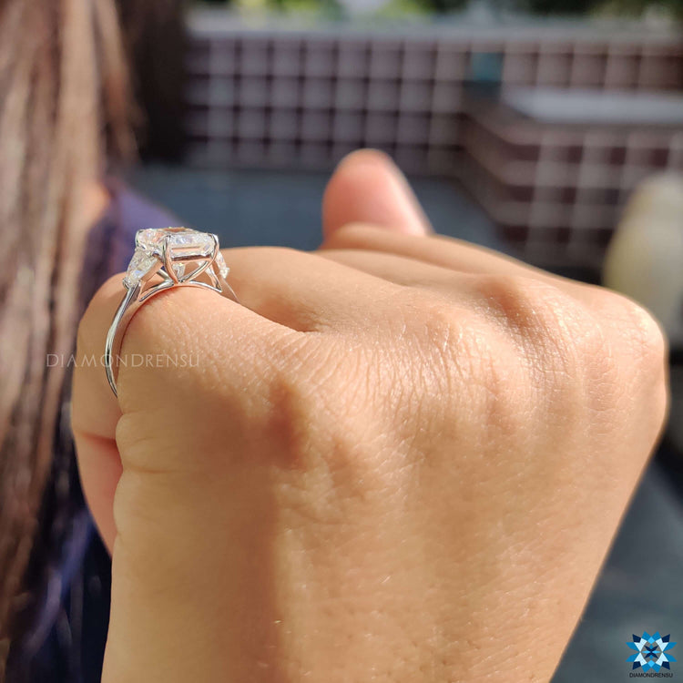 Radiant center stone with trillion moissanite sides in white gold.
