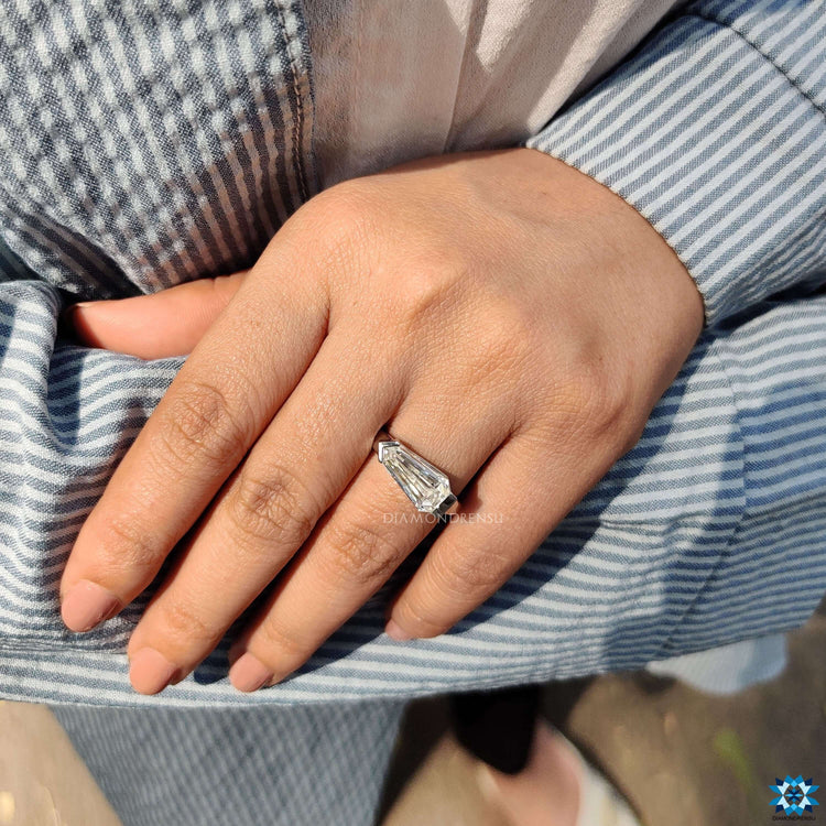Moissanite solitaire ring with shield cut center.
