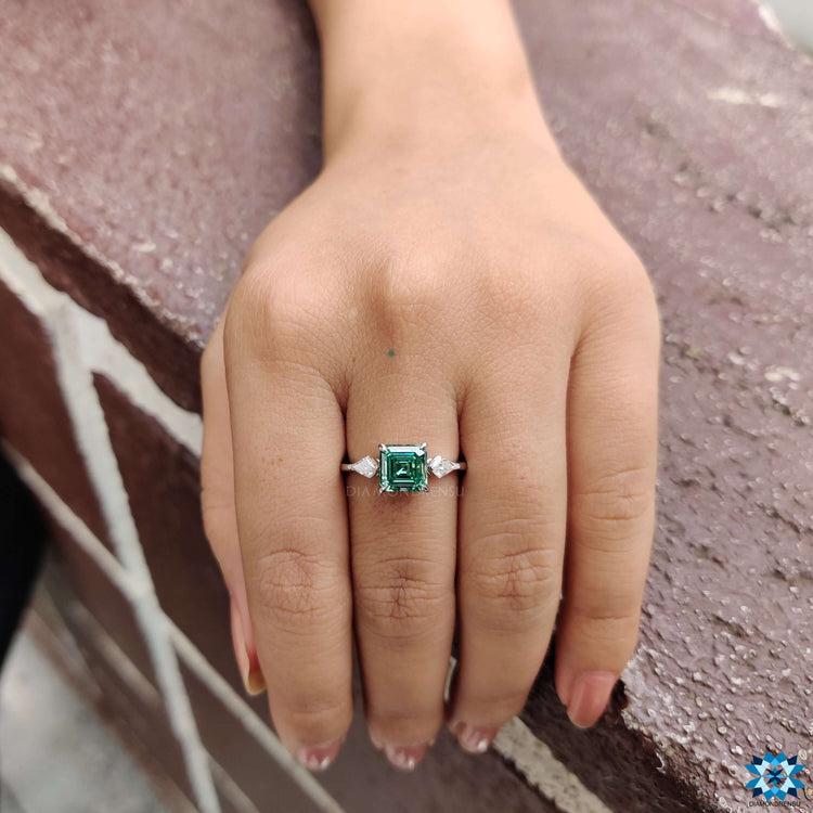 Asscher engagement ring with three stone setting.
