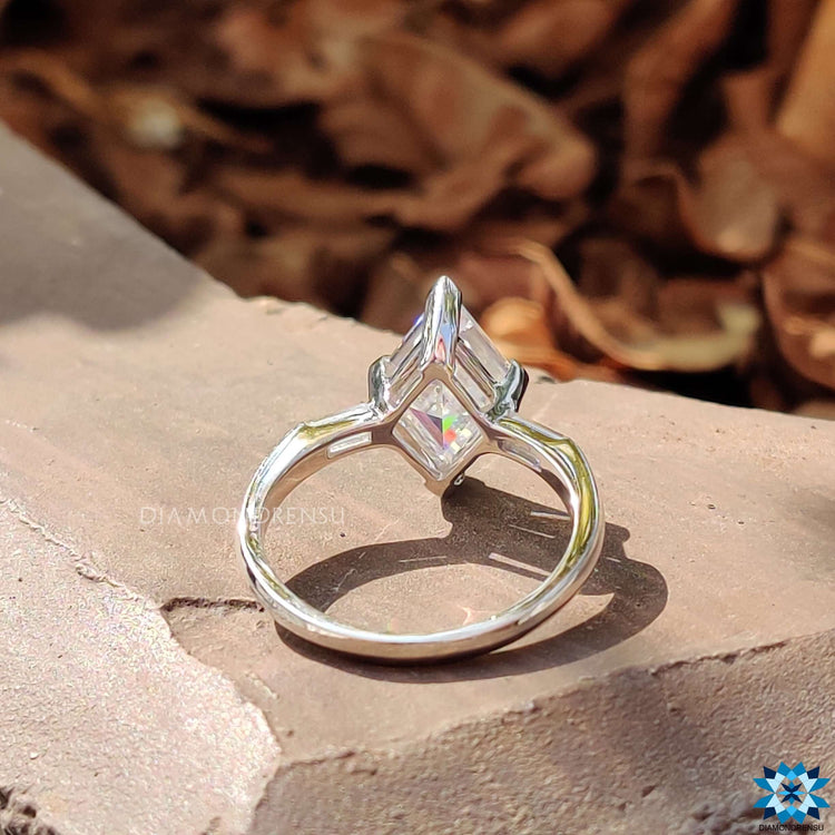 Three stone engagement ring with lozenge and baguette cuts.
