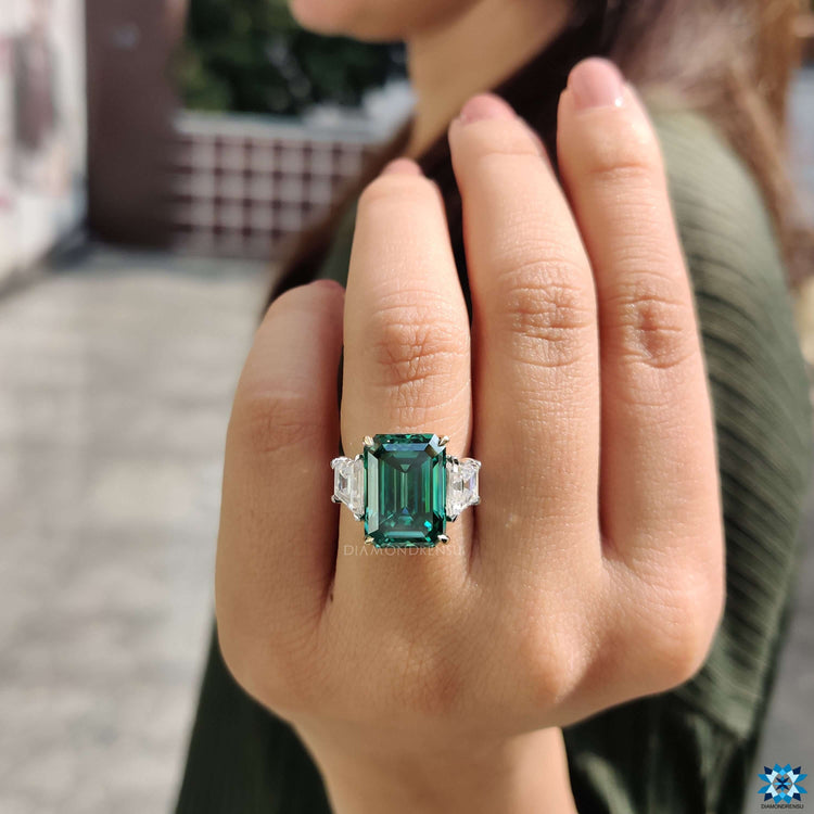 Handmade ring featuring emerald and trapezoid stones.
