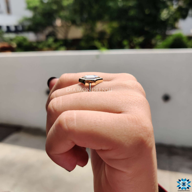 White gold bezel setting ring with moissanite center.
