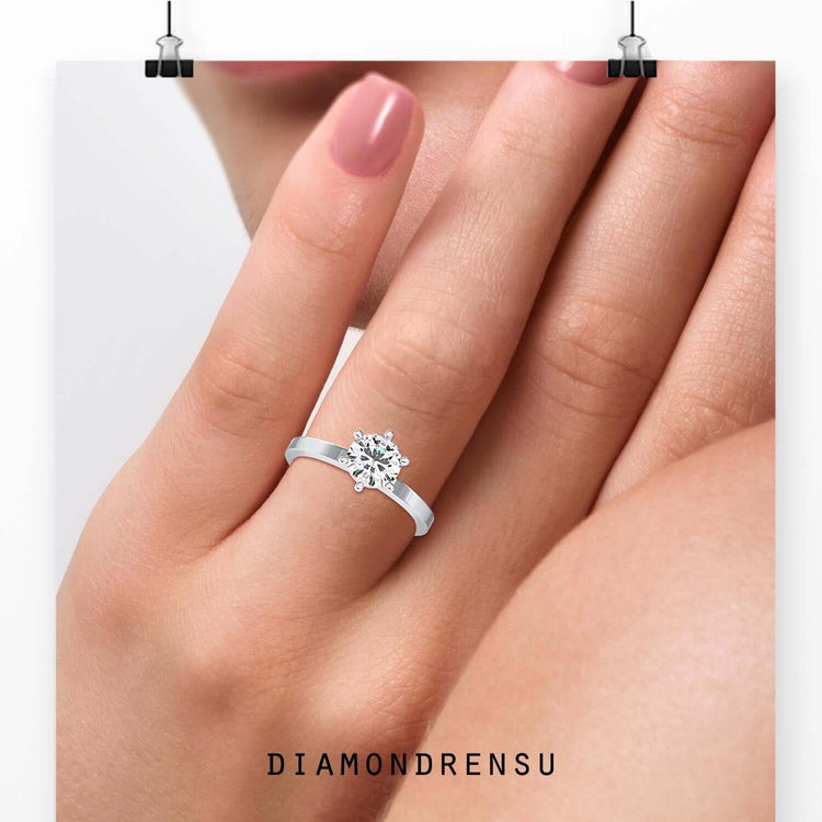Round diamond engagement ring in rose gold solitaire setting.
