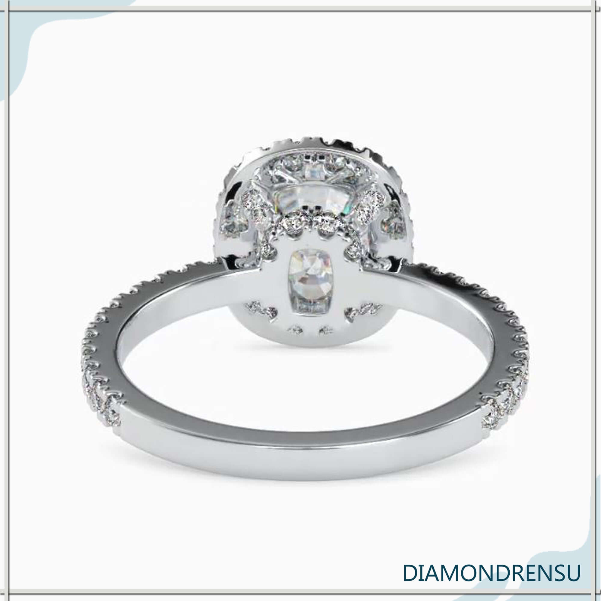 Side stone engagement ring with a cushion cut center and diamond accents.
