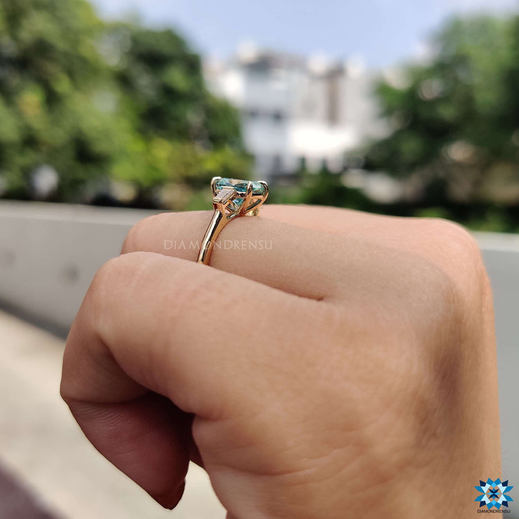 Three stone moissanite ring with unique cushion cut center.
