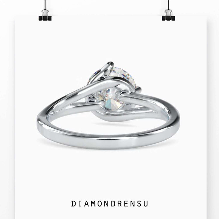 White gold engagement ring with round cut and handmade detail.
