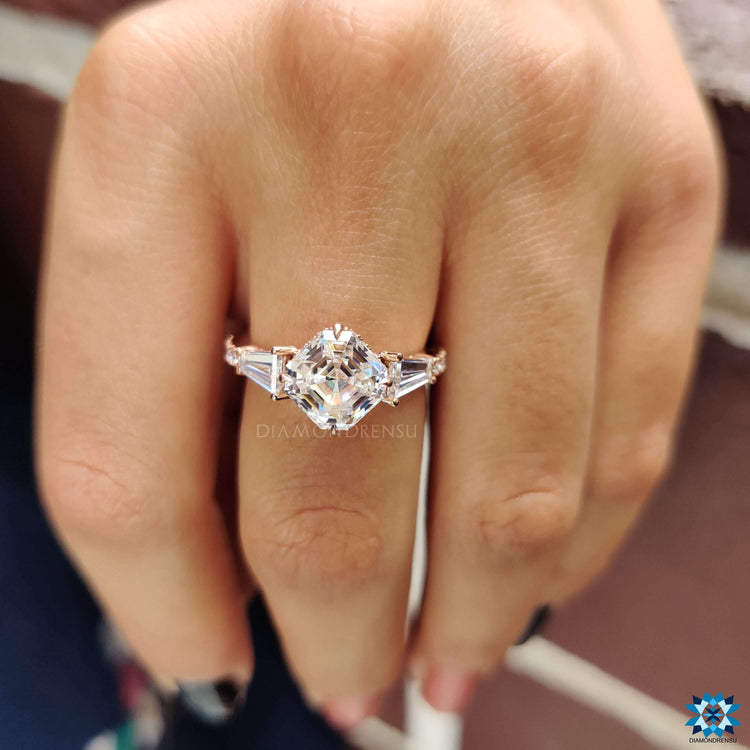 Three stone engagement ring with tapered baguette accents.
