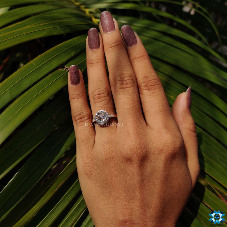 Three stone moissanite ring with round rose cut center stone.
