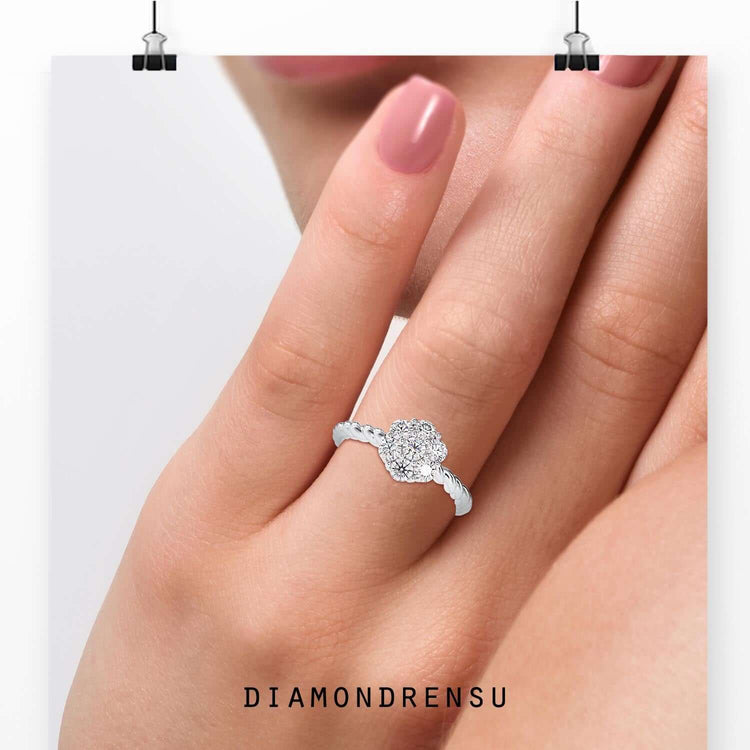 Lab grown twisted engagement ring in rose gold with round prong setting.
