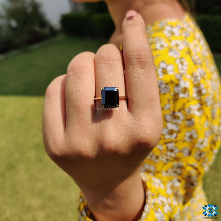 Emerald cut black moissanite solitaire ring.
