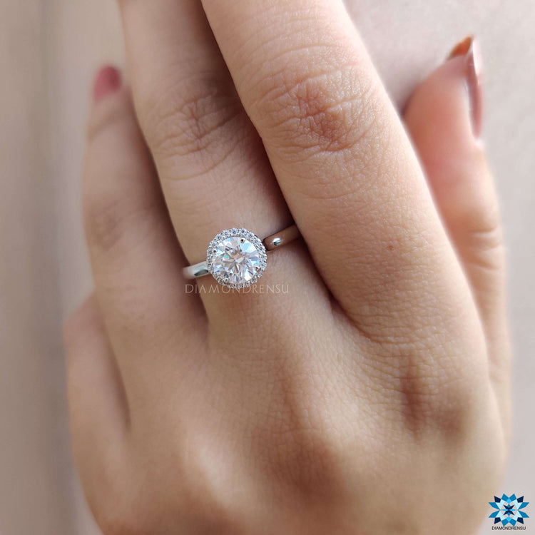 Moissanite ring with round halo and 4 prong mount.
