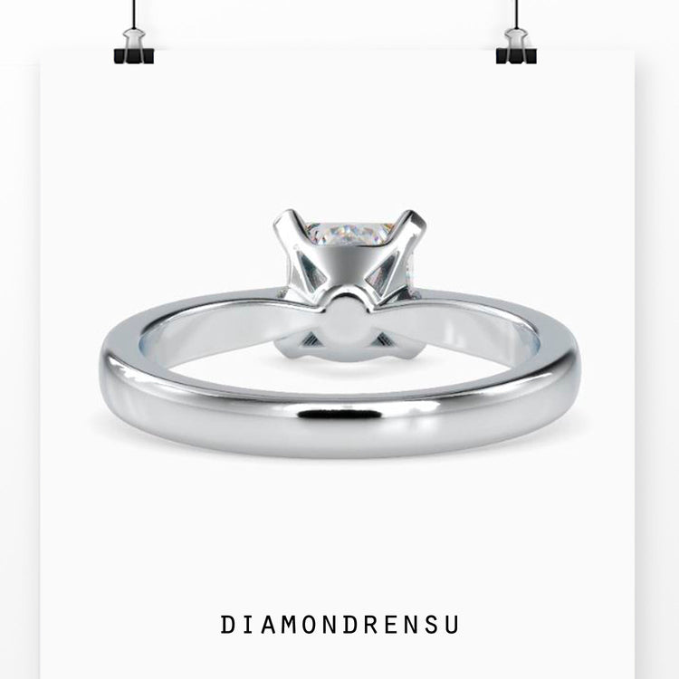 Yellow gold diamond ring with centre princess cut solitaire.
