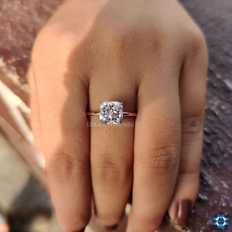 Rose gold engagement ring featuring a cushion Rensu cut center stone.
