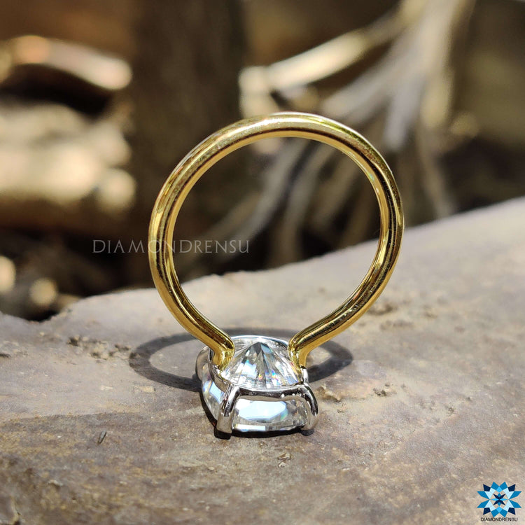 Claw prong setting on elongated cushion moissanite ring.

