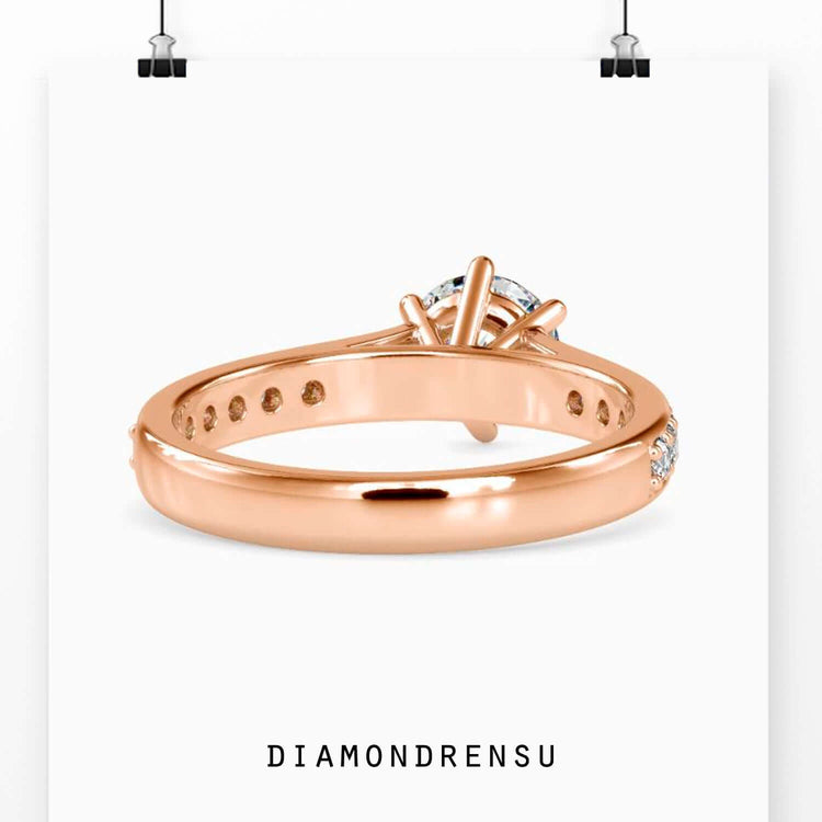 Round diamond side stone ring with cathedral setting.
