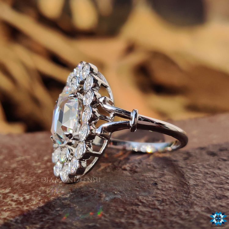 Antique vintage ring with oval moissanite in a halo setting.
