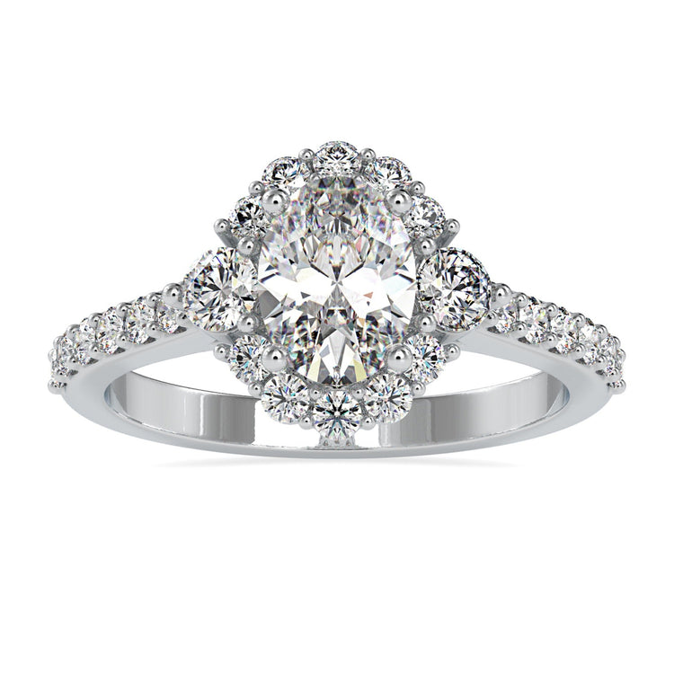 Gold oval diamond engagement ring with cluster halo setting.
