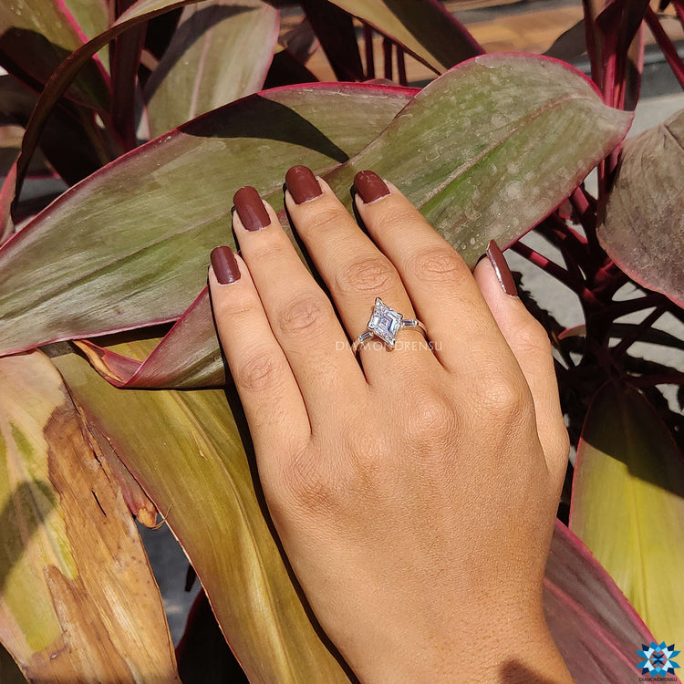 Custom engagement ring featuring lozenge cut center stone.
