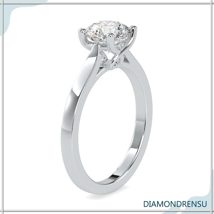 Rose gold engagement ring with round diamond solitaire.
