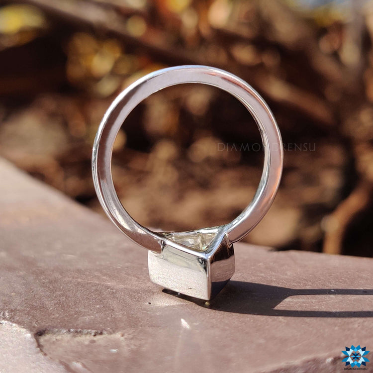 Buy moissanite ring with bezel setting in white gold.
