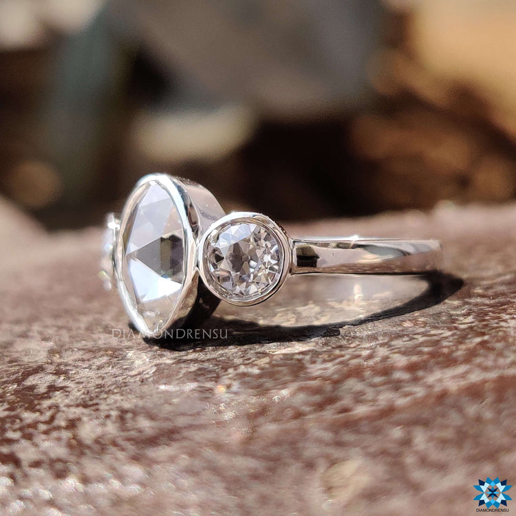 White gold moissanite ring with bezel set design.
