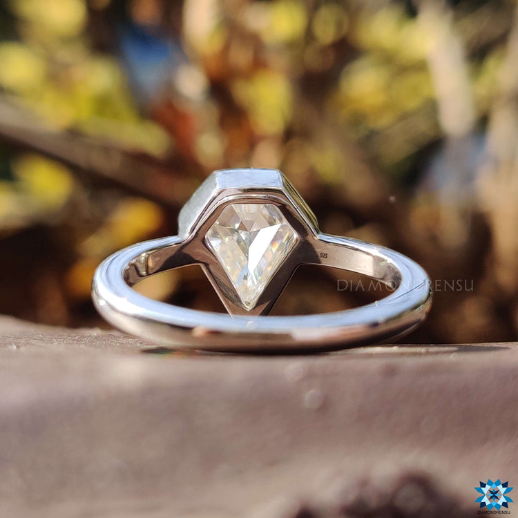 Handmade moissanite ring with shield cut stone.
