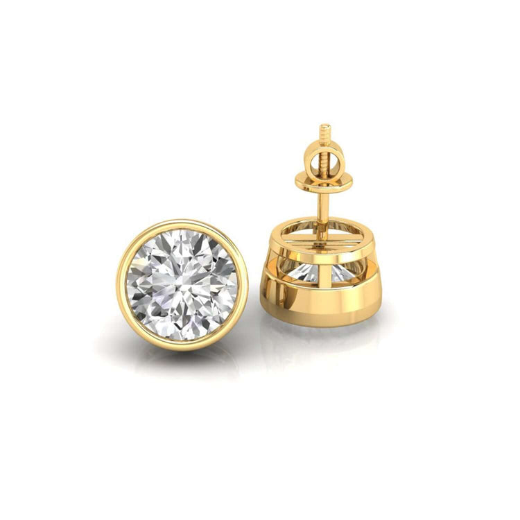 Gold stud earrings holding round diamonds in bezel mount.
