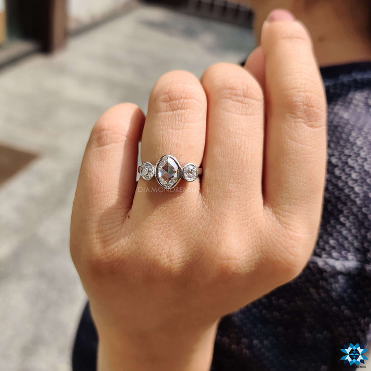 Oval rose cut moissanite ring with round old European cut side stones.
