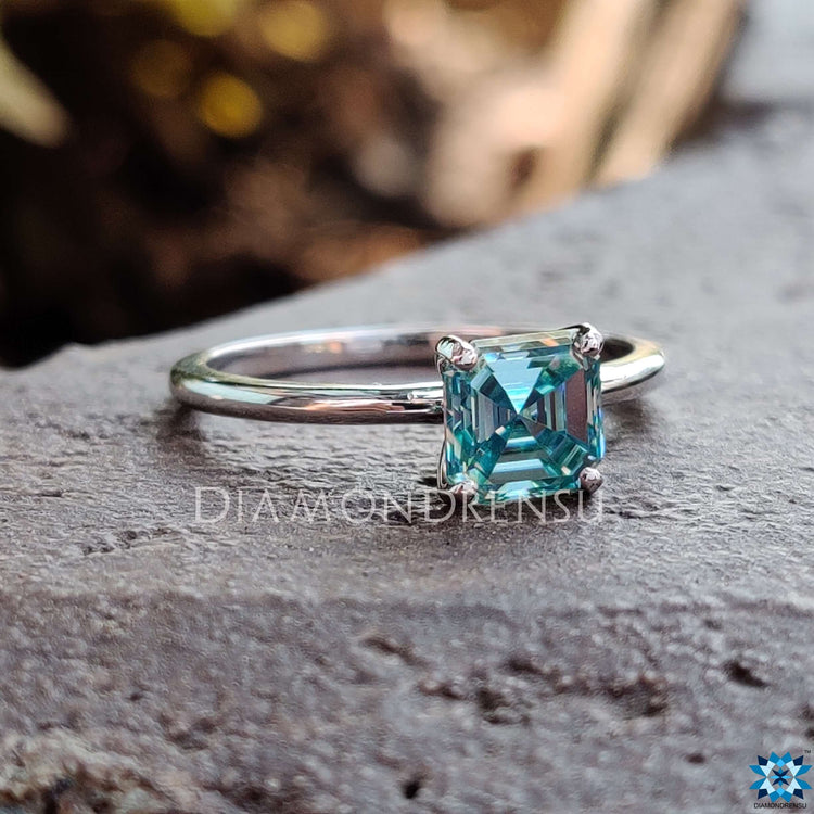 Asscher moissanite ring with four prongs in a clean solitaire setting.
