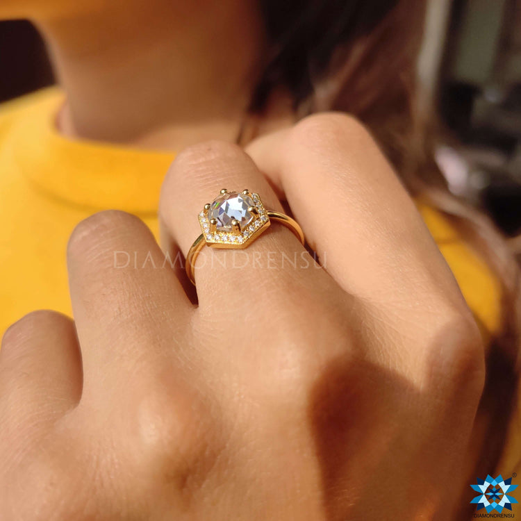 Hexagon halo ring with round moissanite center.

