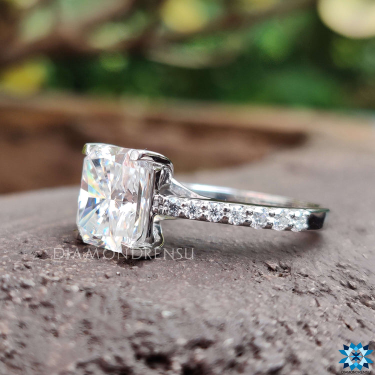 Round cut pave band crafted in white gold with radiant moissanite.
