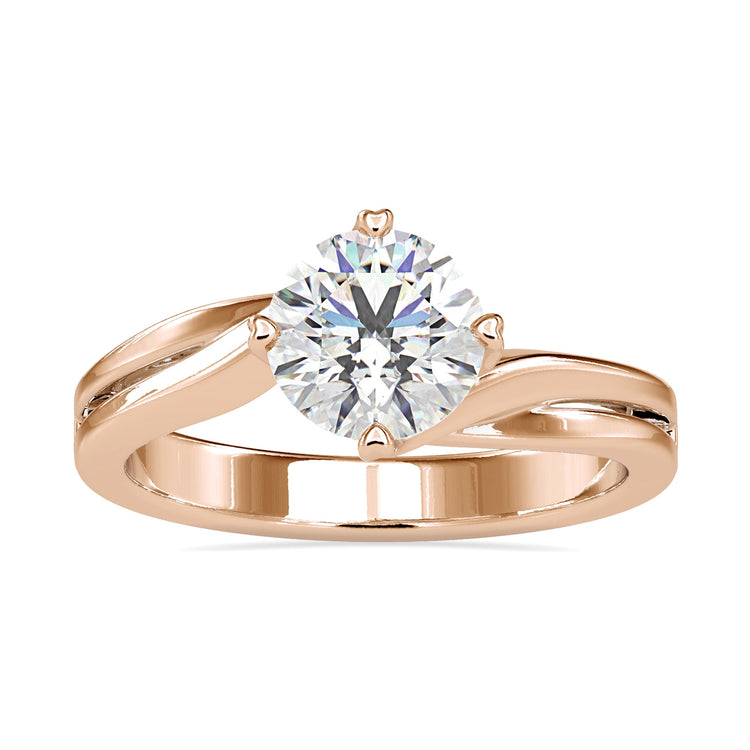 Solitaire diamond ring with heart prong setting in rose gold.
