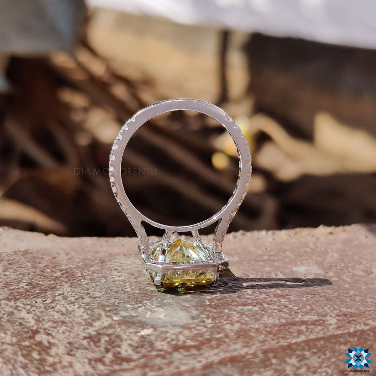 Handmade halo ring with radiant cut yellow center stone.
