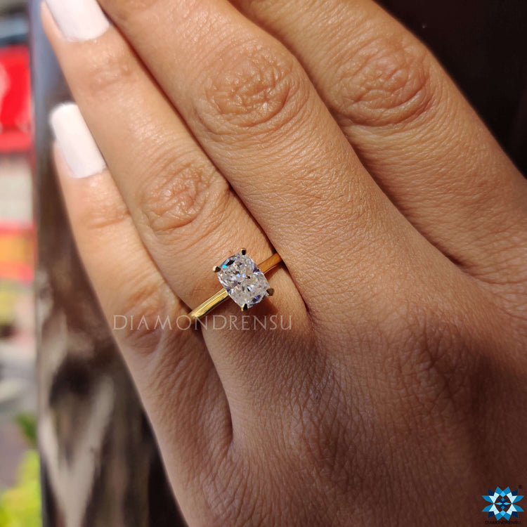 Yellow gold moissanite ring with a cathedral setting for added height and elegance.
