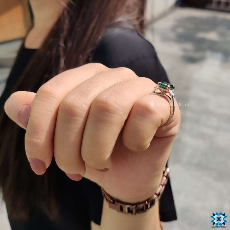 Split shank ring with Asscher center and round halo design.
