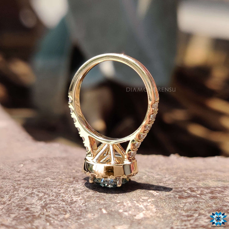 Moissanite halo ring in yellow gold.

