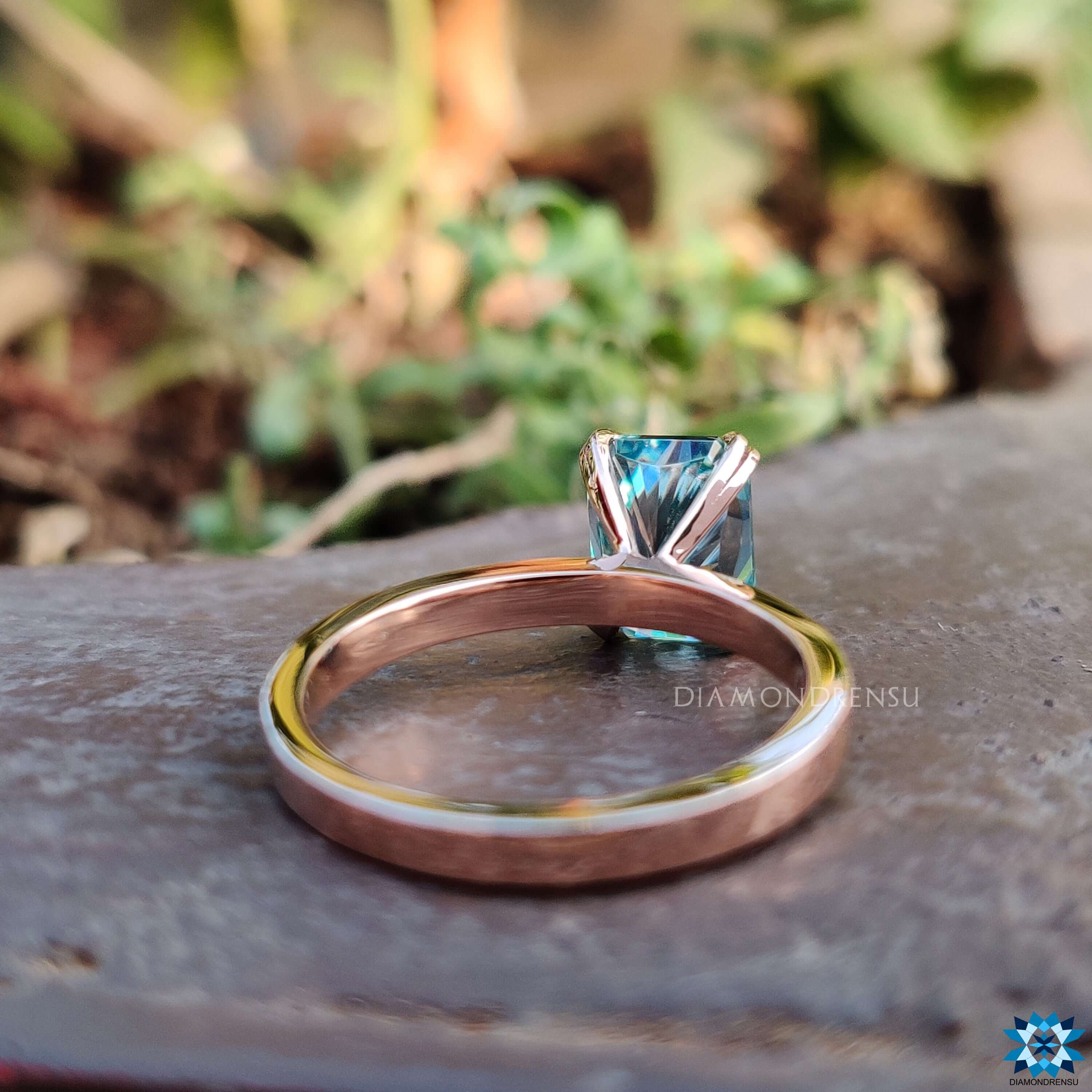 Shop to buy engagement ring with a radiant cut moissanite ring and a blue stone.