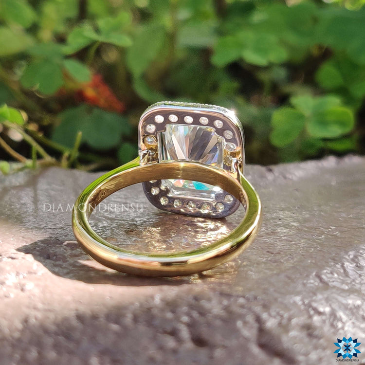 Radiant engagement ring with 4 prong mount and vintage touch.
