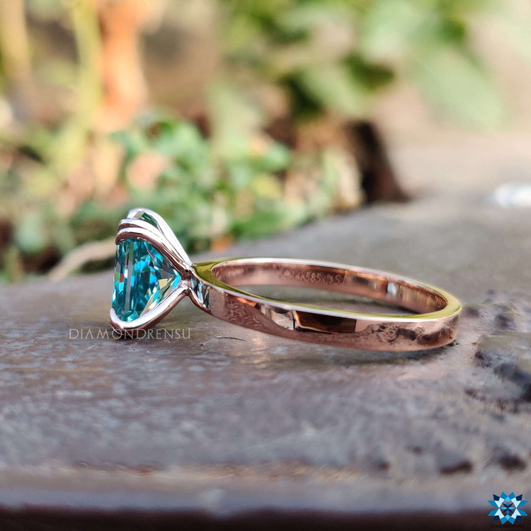 Simple Ring with a blue moissanite ring centre for a clean and timeless design.