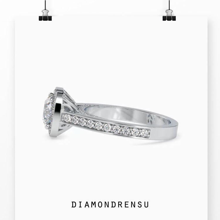 White gold diamond ring with round cut and halo detail.
