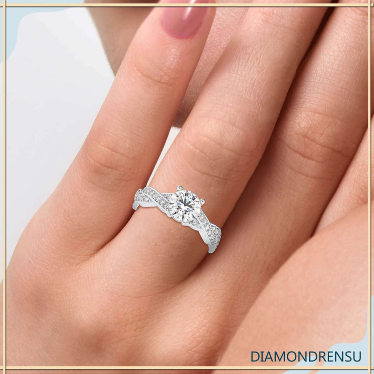 Round cut twisted band ring in white gold setting.
