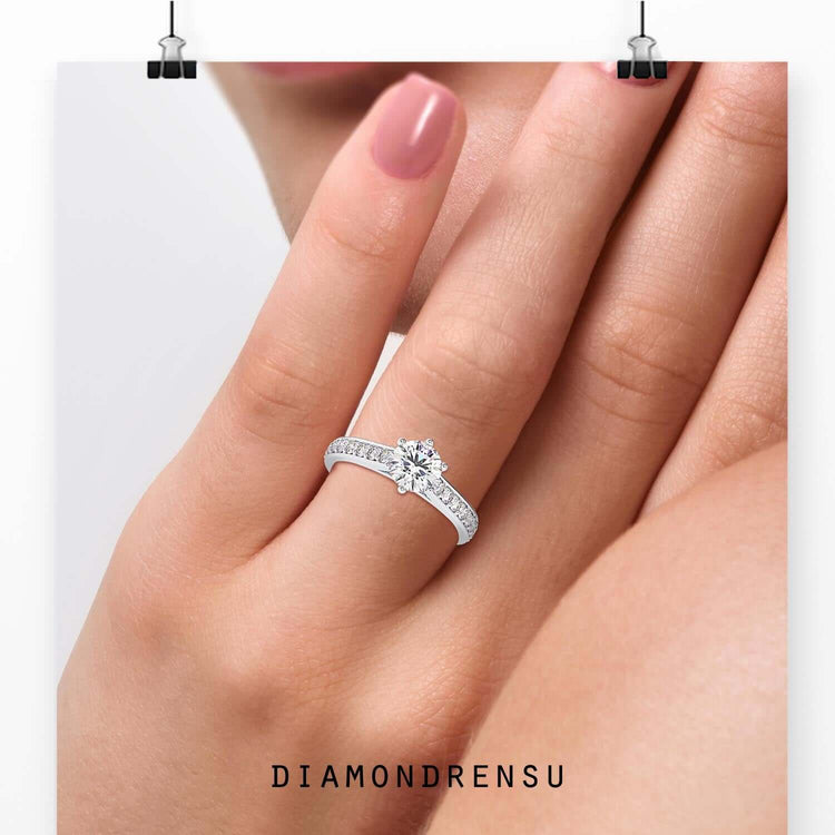 Cathedral setting ring with round cut diamond in white gold.
