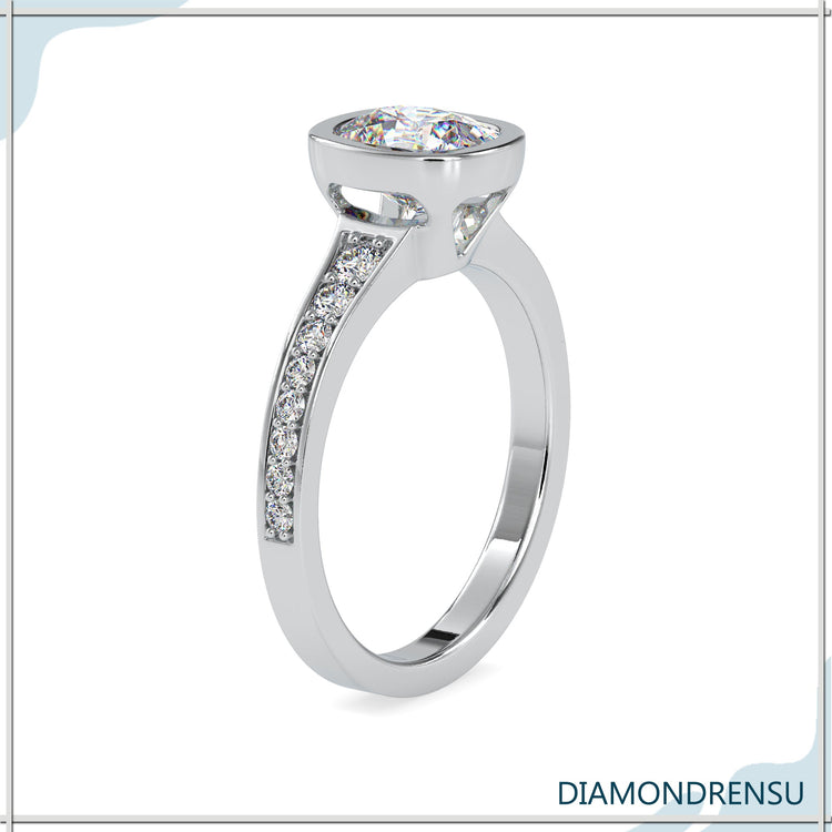 Rose gold ring featuring bezel mounted cushion diamond.
