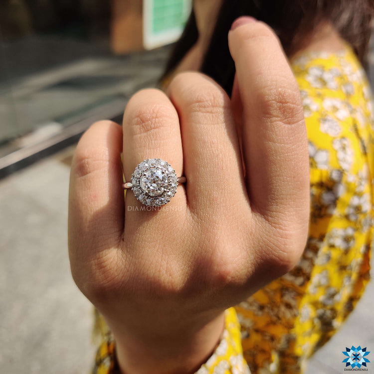 Round cut moissanite ring with cluster halo design.
