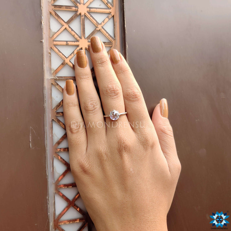 Custom ring design featuring a round cut moissanite ring in a white gold engagement ring.