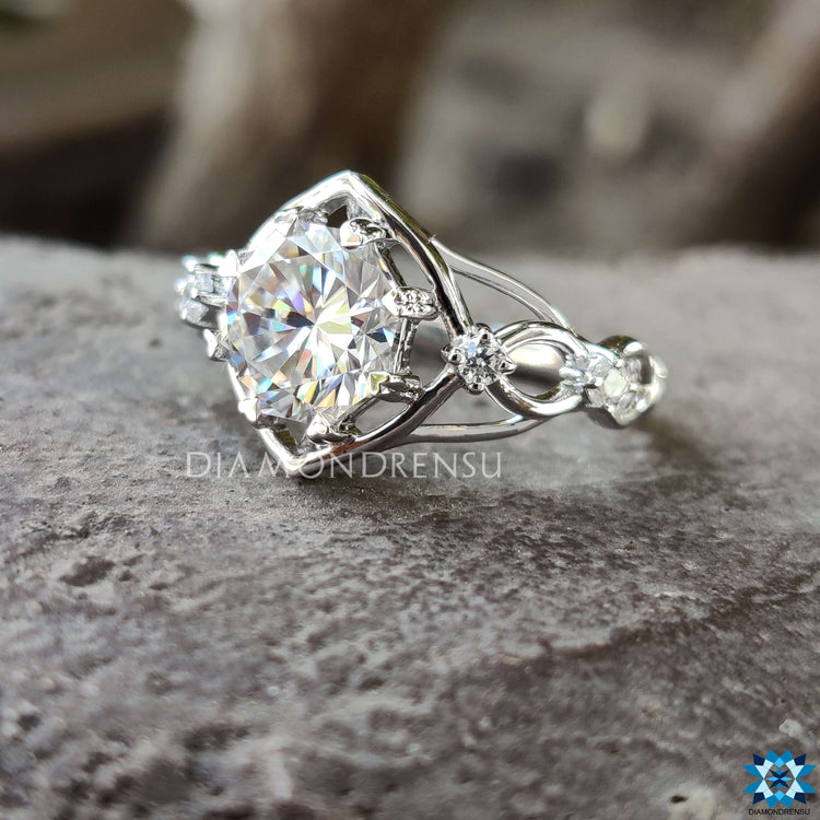 Vintage style engagement ring with round moissanite.
