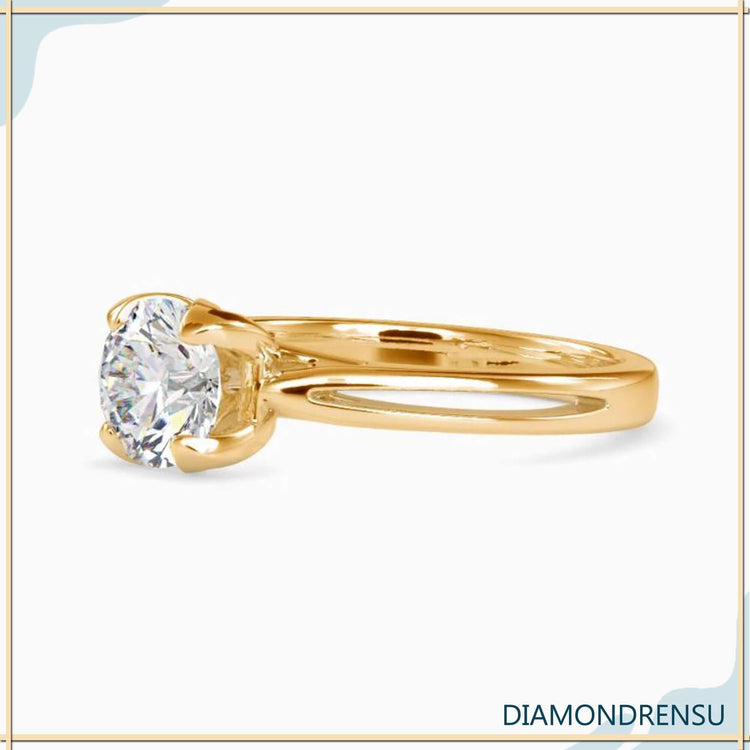 Yellow gold engagement ring featuring a tulip-inspired solitaire design.
