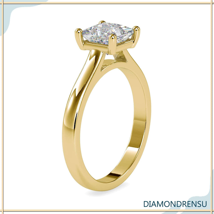 IGI certified princess diamond ring in yellow gold cathedral design.
