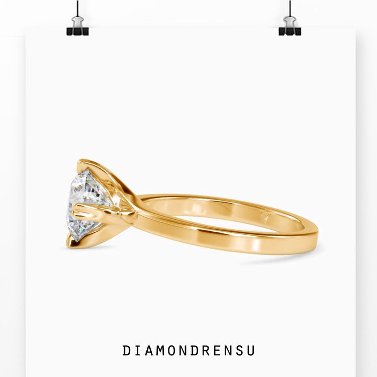 Yellow gold ring with heart prong and round diamond.
