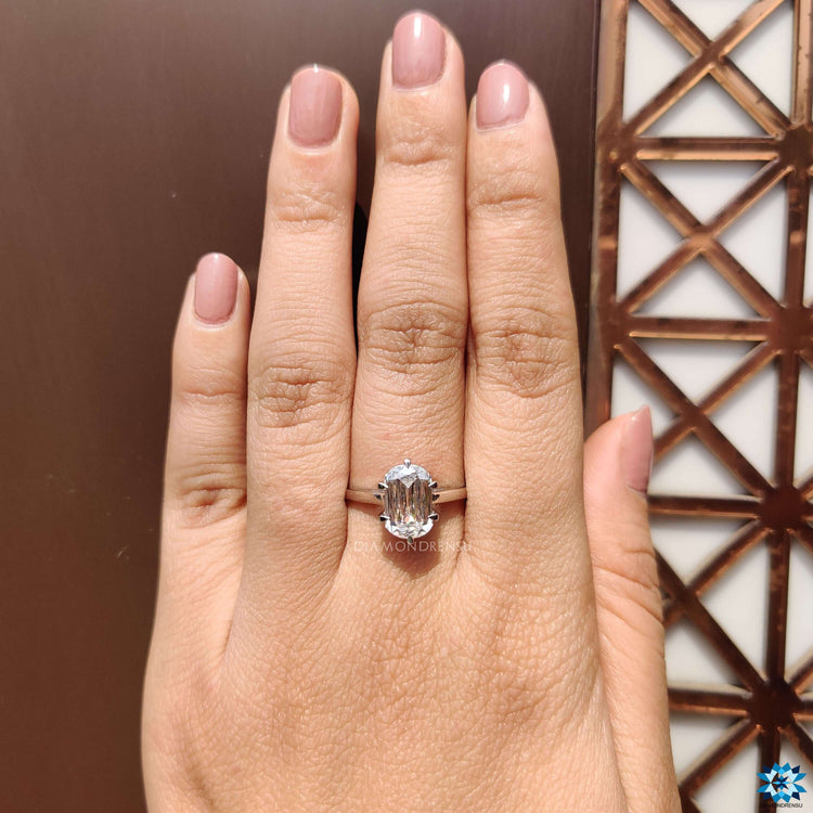 White gold moissanite ring with six prong claw setting.
